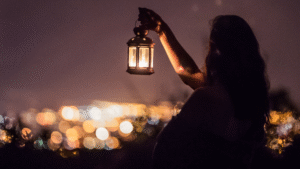 Woman holding lantern in the dark